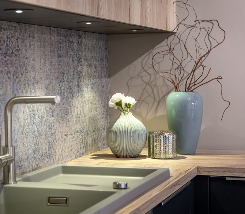 Steel faucet close-up in the interior of a modern kitchen.