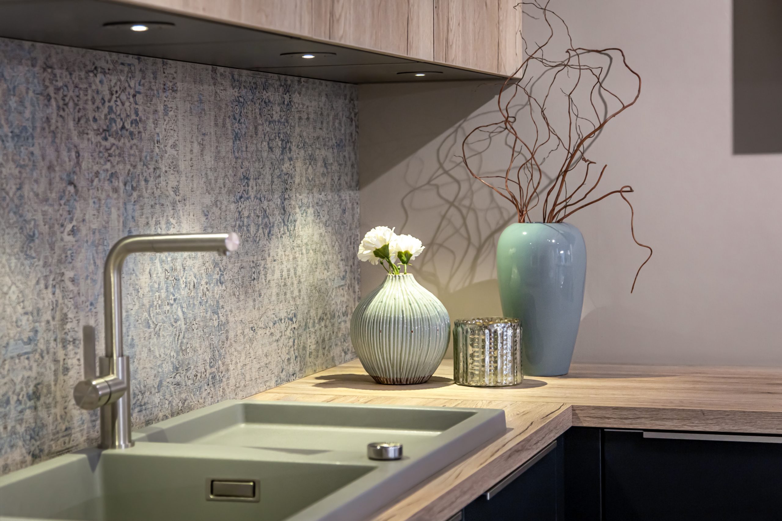 Steel faucet close-up in the interior of a modern kitchen.